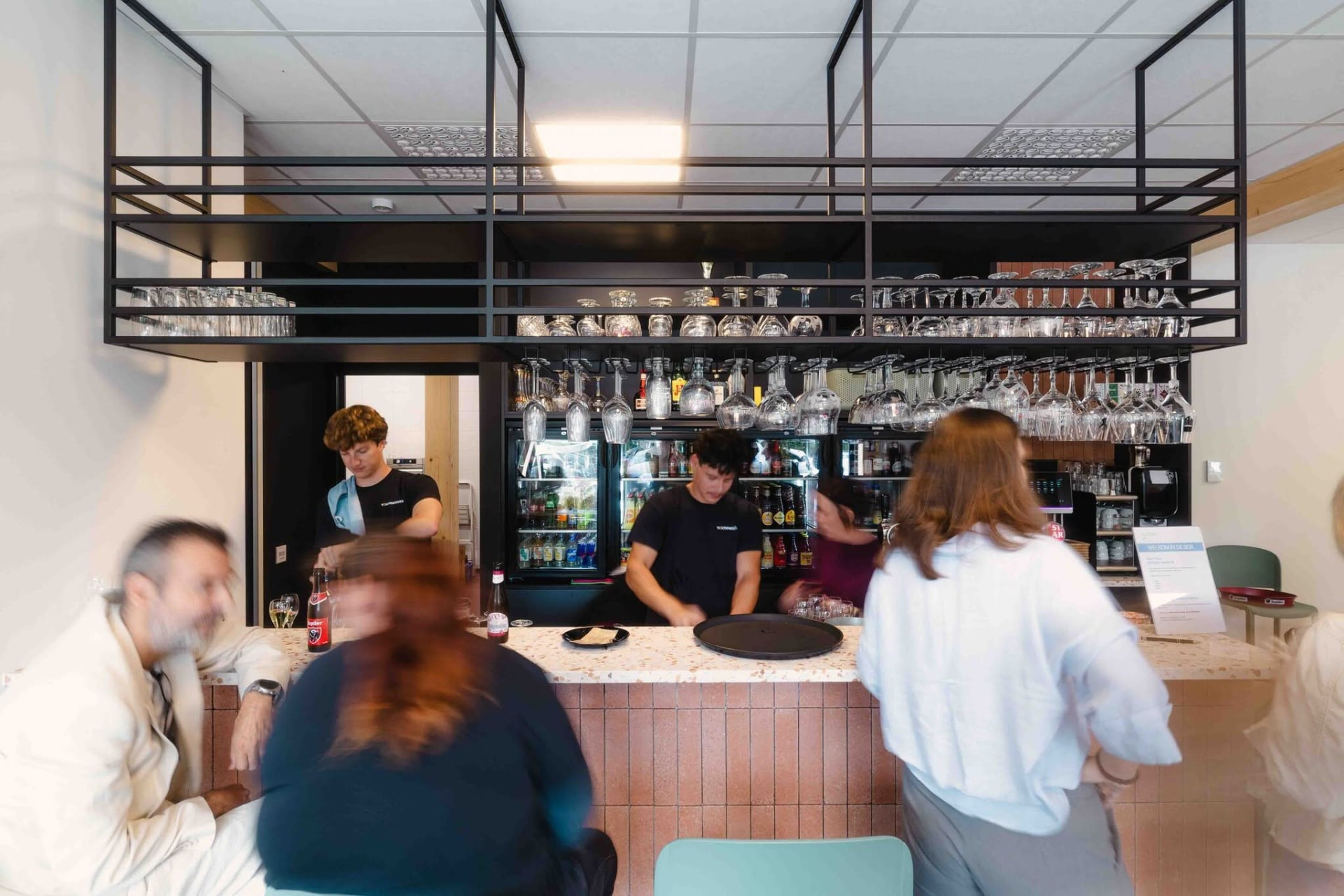 Bezoekers aan de toog van Eetcafé De Sok tijdens de opening